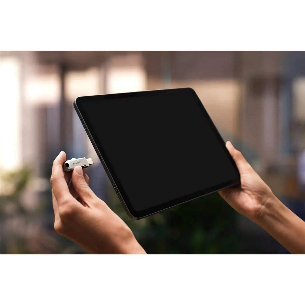 Person using SanDisk Ultra Dual Drive Luxe USB Type-C with tablet.