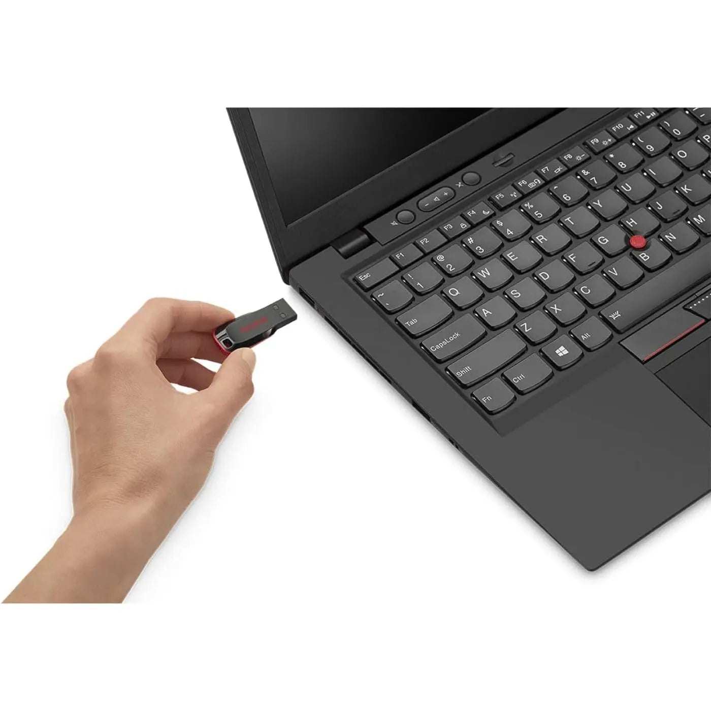 Hand inserting SanDisk Cruzer Blade USB flash drive into laptop.