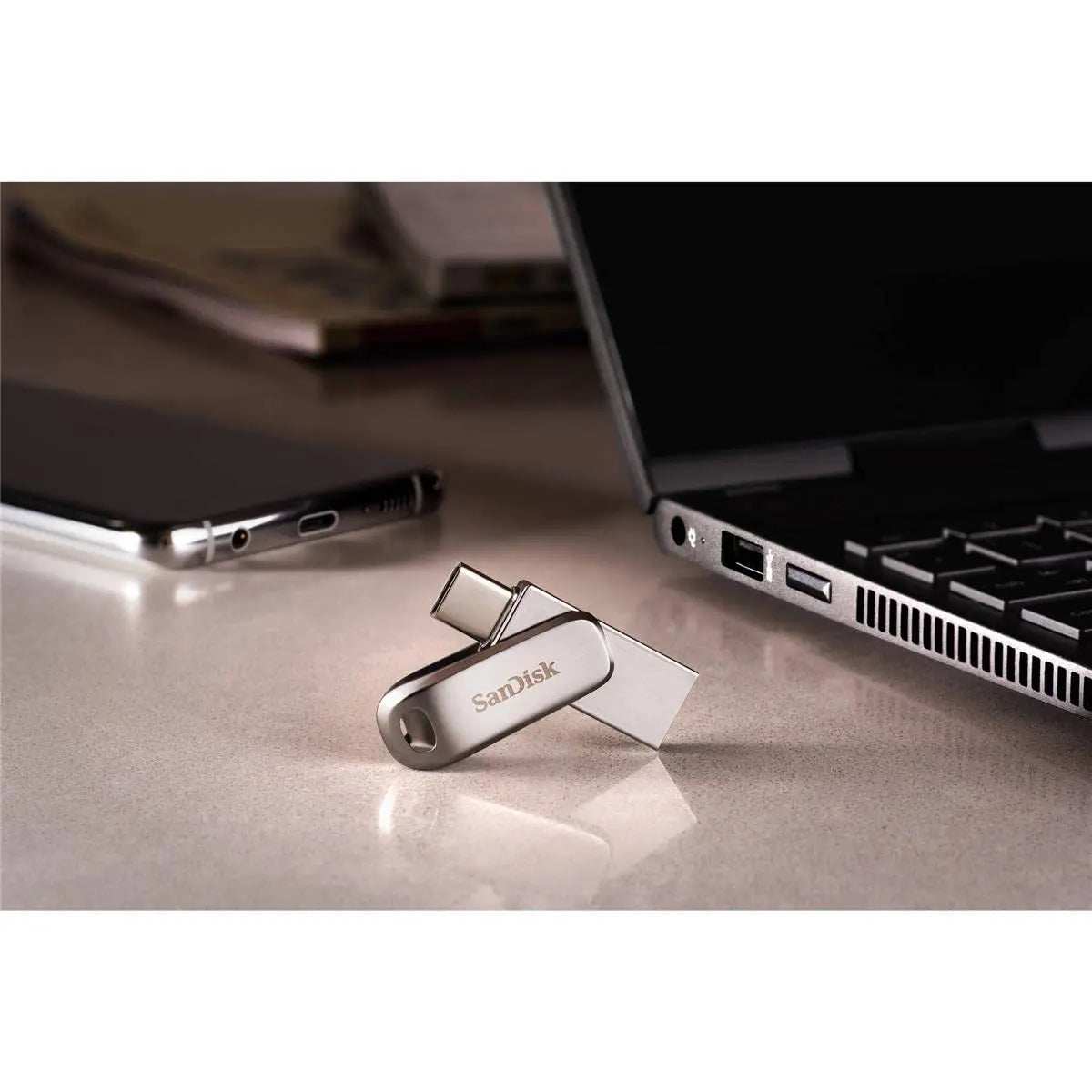 SanDisk Ultra Dual Drive Luxe USB Type-C connected to a laptop, showcasing its versatile 2-in-1 design.