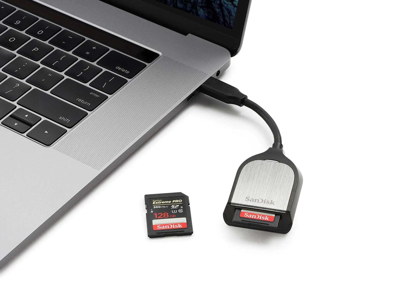 SanDisk Extreme PRO SDXC UHS-II Memory Card with USB-C Reader connected to laptop.