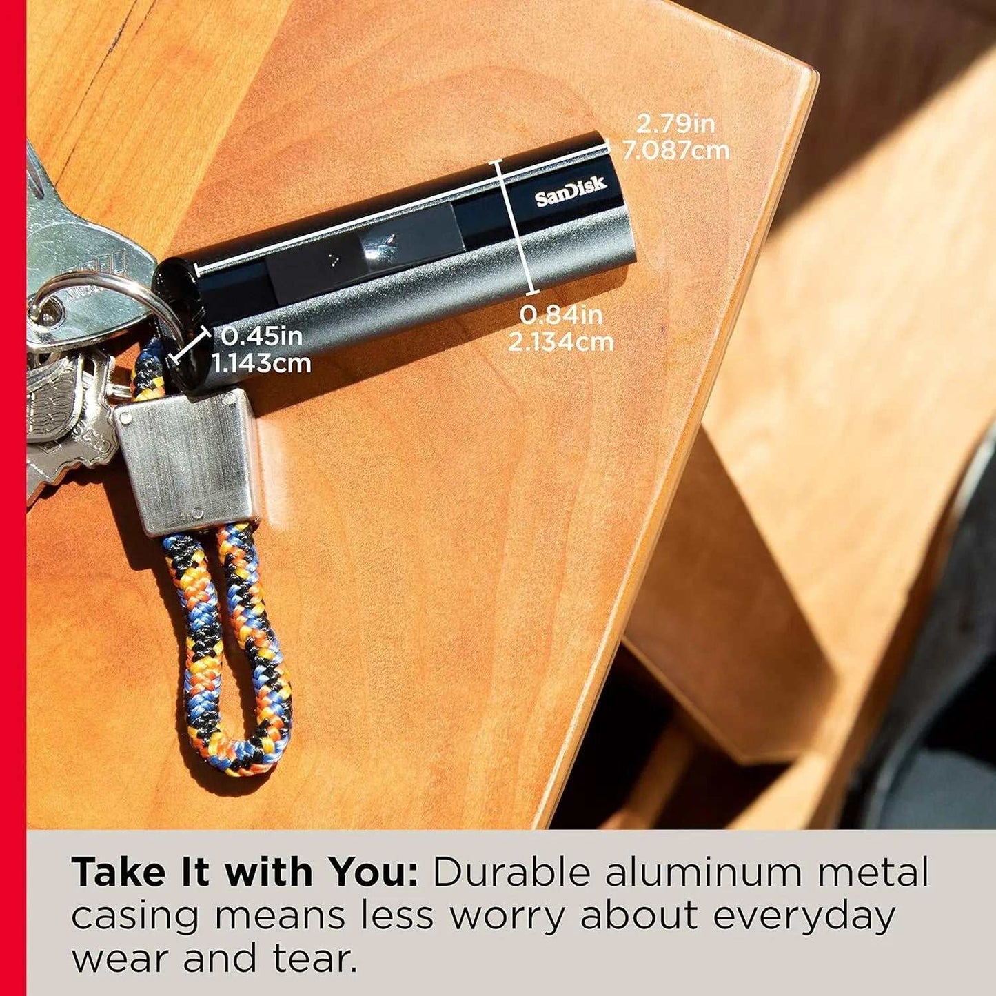 SanDisk Extreme PRO USB 3.2 flash drive with durable aluminum casing next to keys.