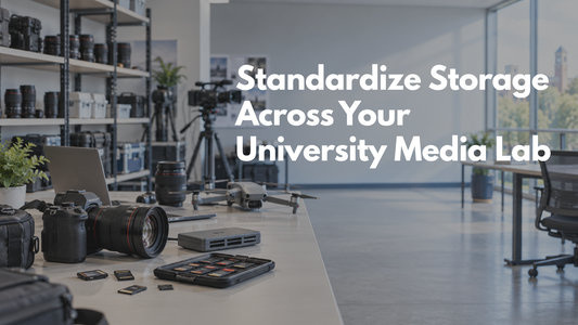 University media lab with cameras, lenses, drones, card readers, and memory cards arranged on a shared equipment table.