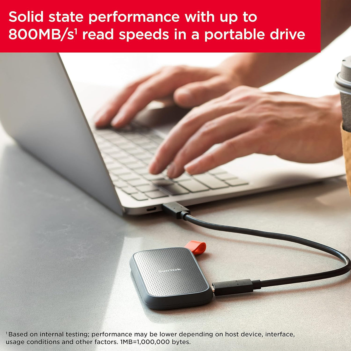 SanDisk portable SSD – drive connected to a laptop with read speed callout