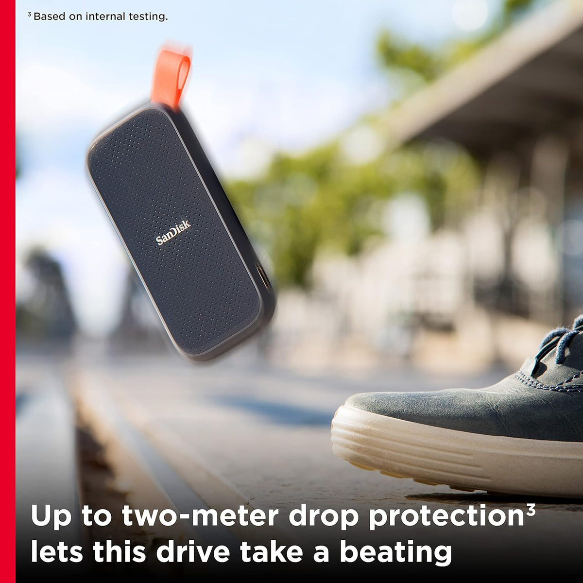 SanDisk portable SSD – drive dropping beside a sneaker showing two-meter drop protection