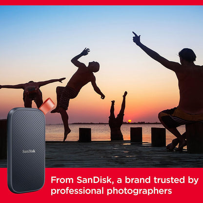 SanDisk portable SSD – drive in front of a sunset photo of people jumping on a pier
