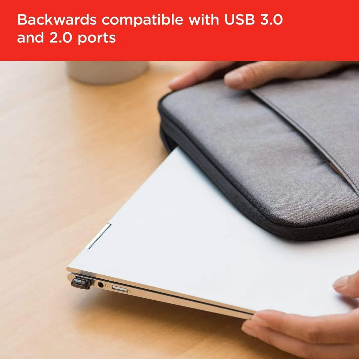 Ultra Fit USB 3.2 flash drive – flash drive plugged into a laptop being slipped into a sleeve