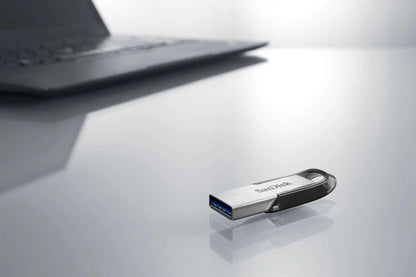 Ultra Flair USB 3.0 flash drive – flash drive on a desk beside a laptop